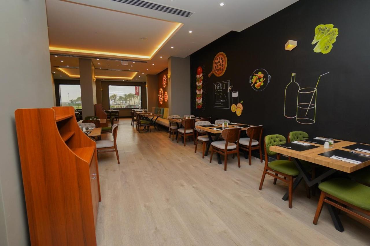 The Grand Lux Hotel Доха Екстериор снимка Interior of a restaurant in Cairo, Egypt